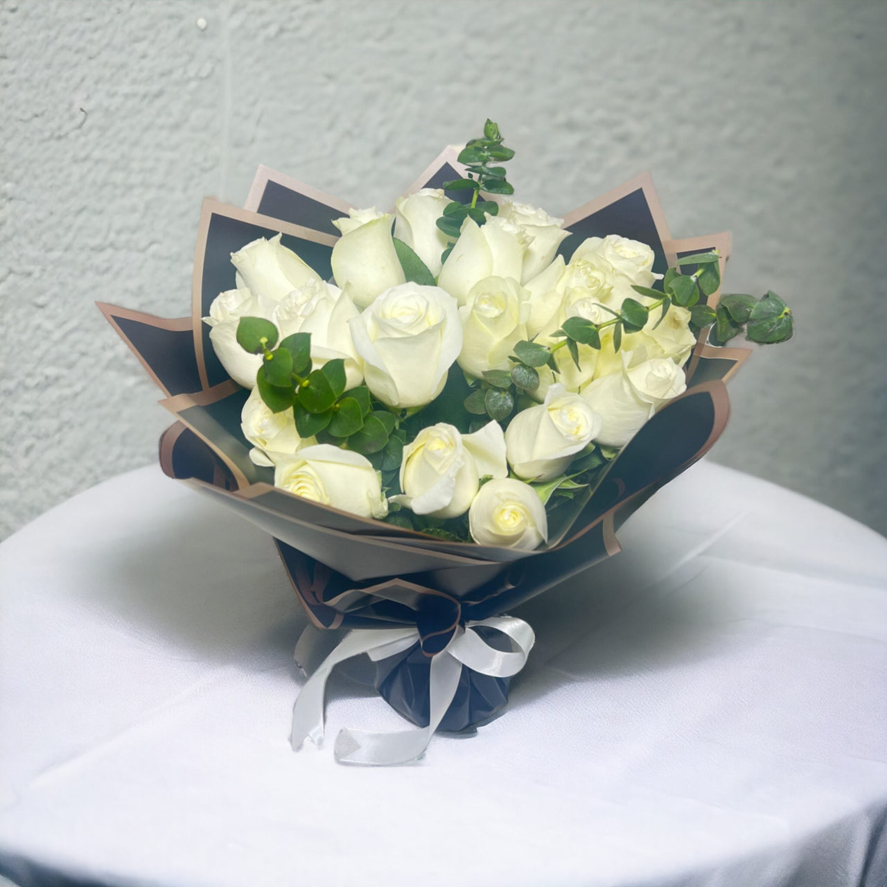 Serenity White Rose Medley, White Roses, Eucalyptus, Black Wrapping, White Ribbon