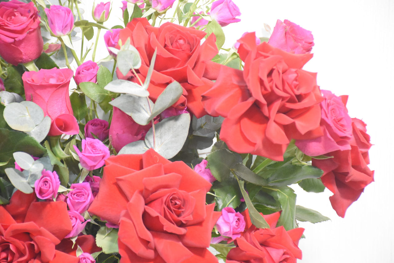 Red Roses and Pink Spray Roses in Ceramic Vase